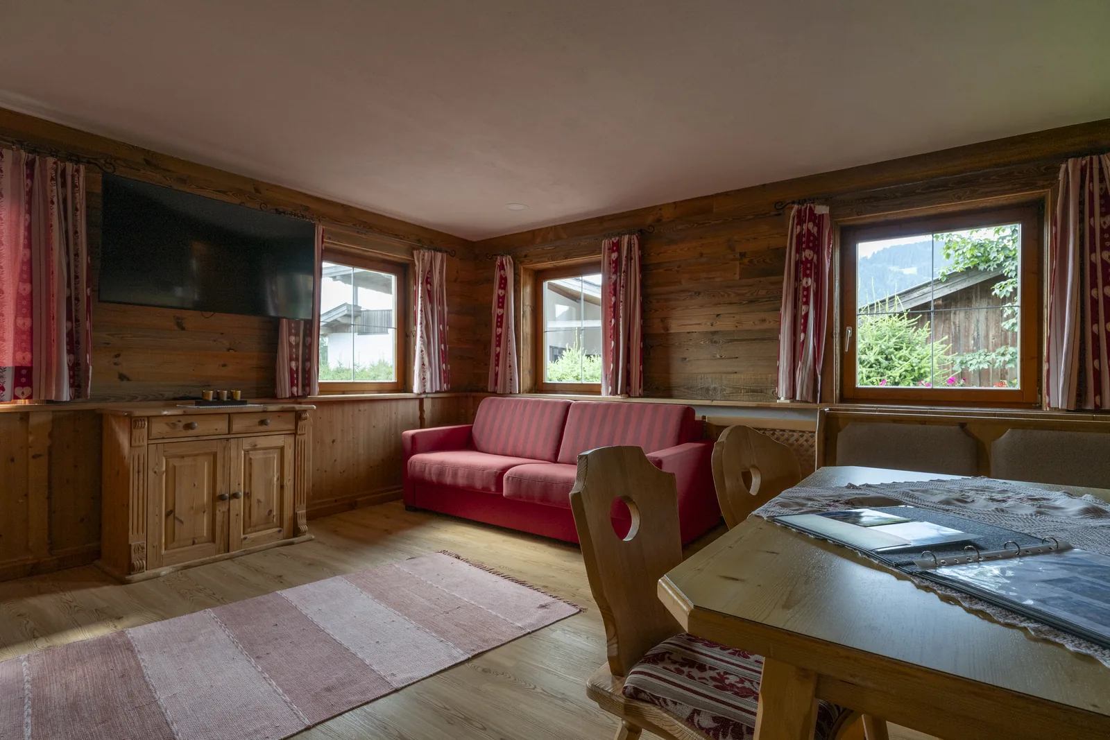 Living room in the Astbergblick apartment looking out onto the greenery